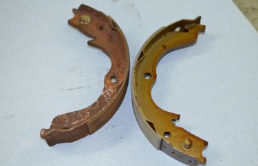 Старые и новые тормозные колодки стояночного тормоза Мицубиси Аутлендер